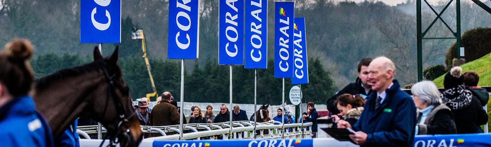 A Chepstow Racecourse sponsor's (Coral) flag is highly visible around the parade ring.