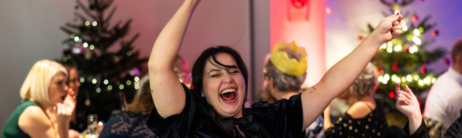Woman smiling and enjoying herself at Christmas Party.
