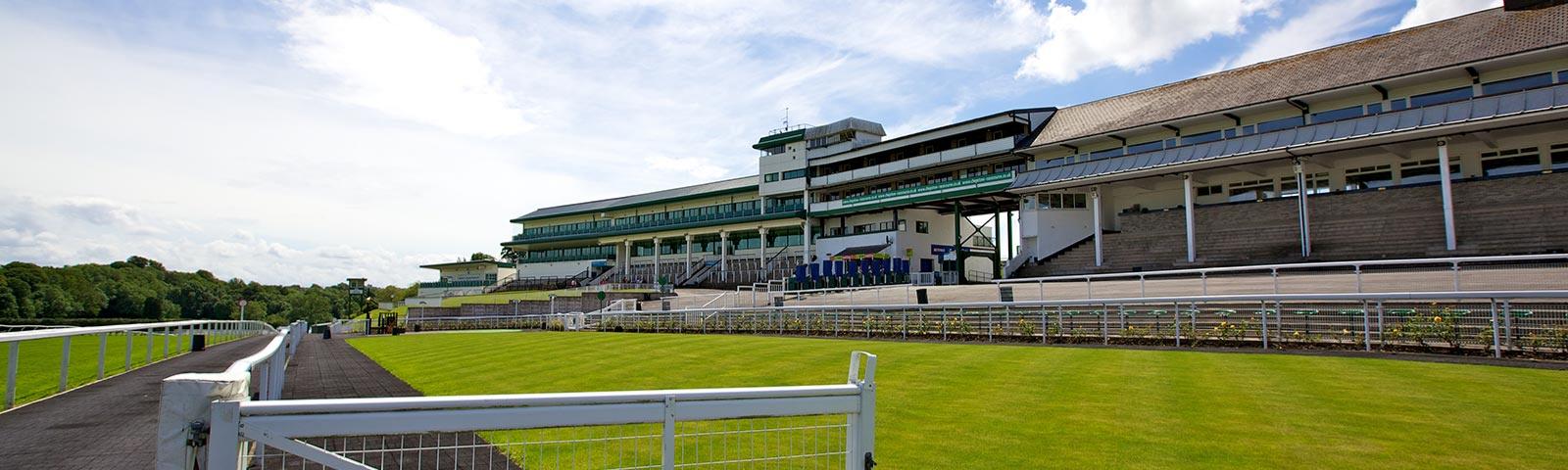 View of the parade ring and the grandstand at Chepstow Racecourse.