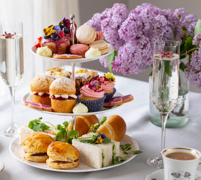 afternoon tea on a 3 tiered cake stand, cups of tea and champagne