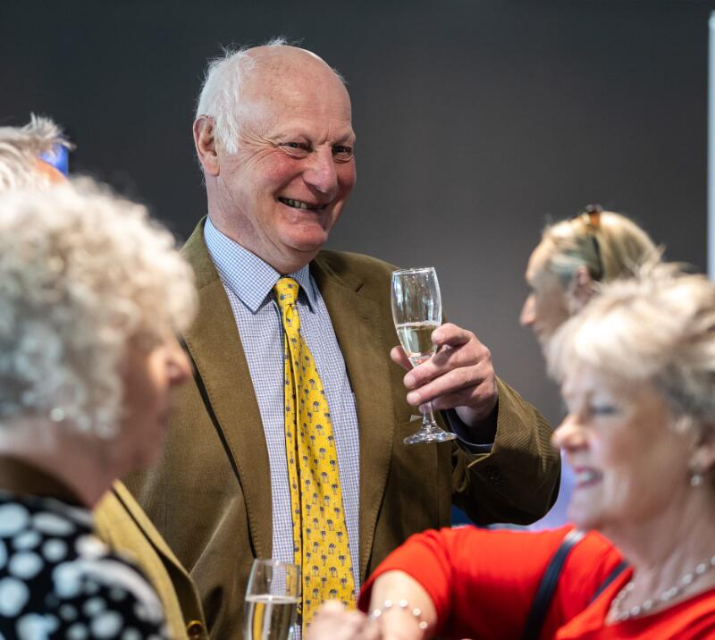 A smartly dressed gent enjoying some bubbles at Chepstow Racecourse