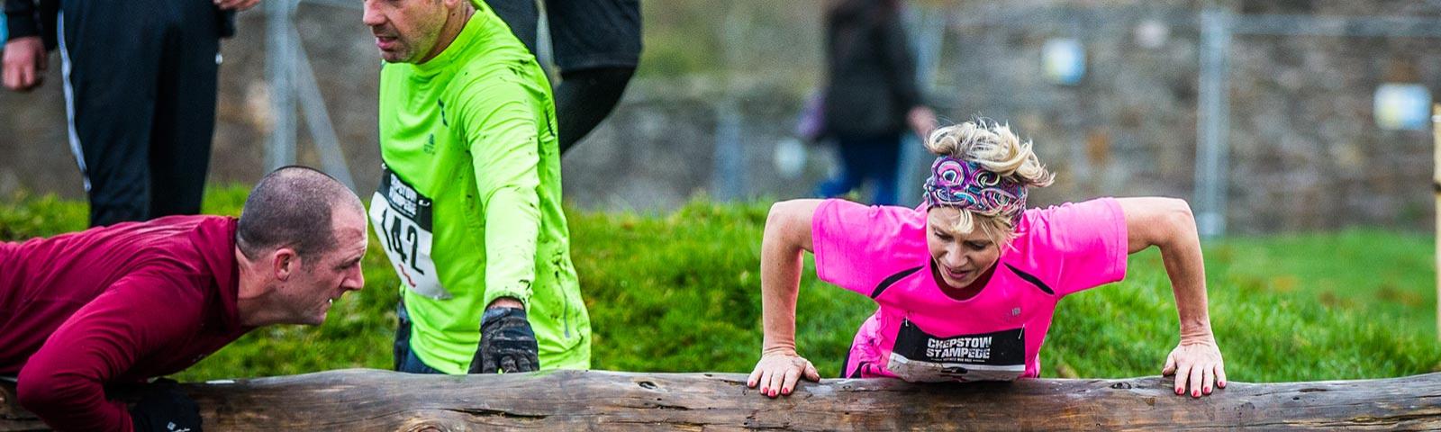 Competitors climb over one of Chepstow Stampede's obstacles.