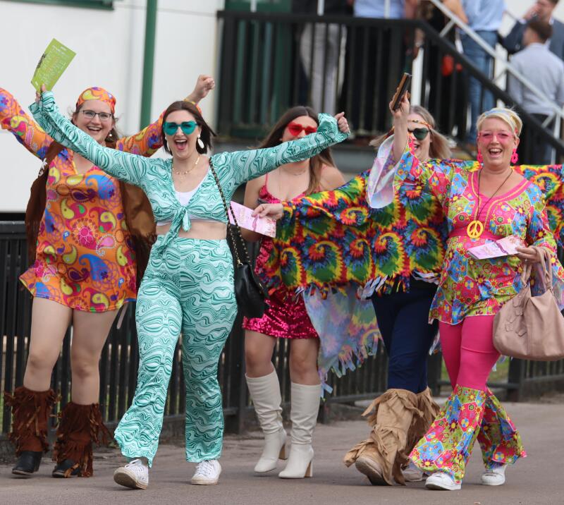 A group of racegoers in fancy dress entering Chepstow Races