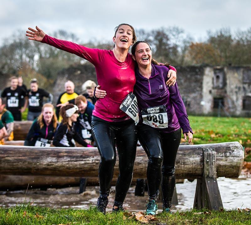 Two competitors celebrate after completing the Chepstow Stampede course.