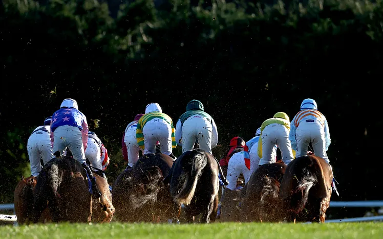 A photo of 10 jockeys racing away 