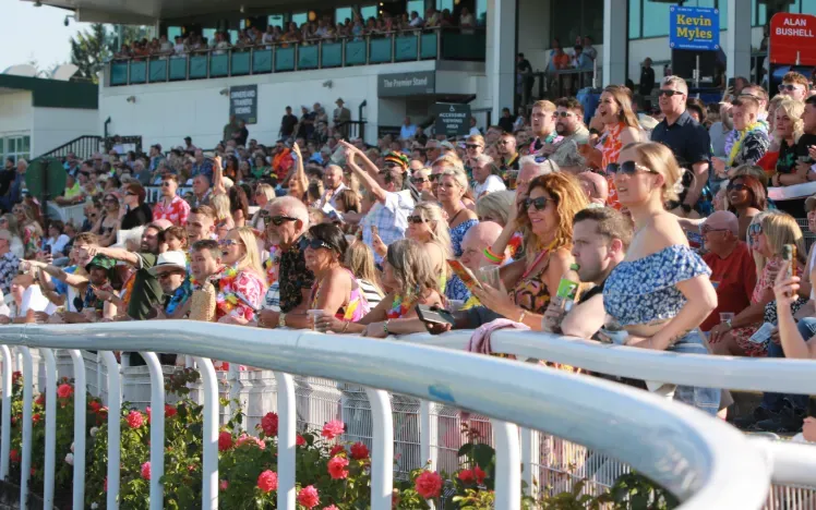 A very brightly dressed crowd at Chepstow watch the races