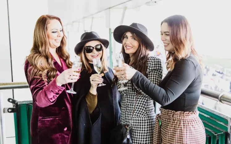Four ladies toast champagne at Chepstow Races