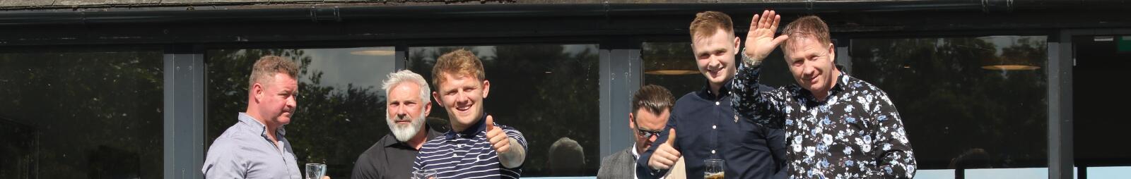 A group of guys enjoying the races at Chepstow Racecourse