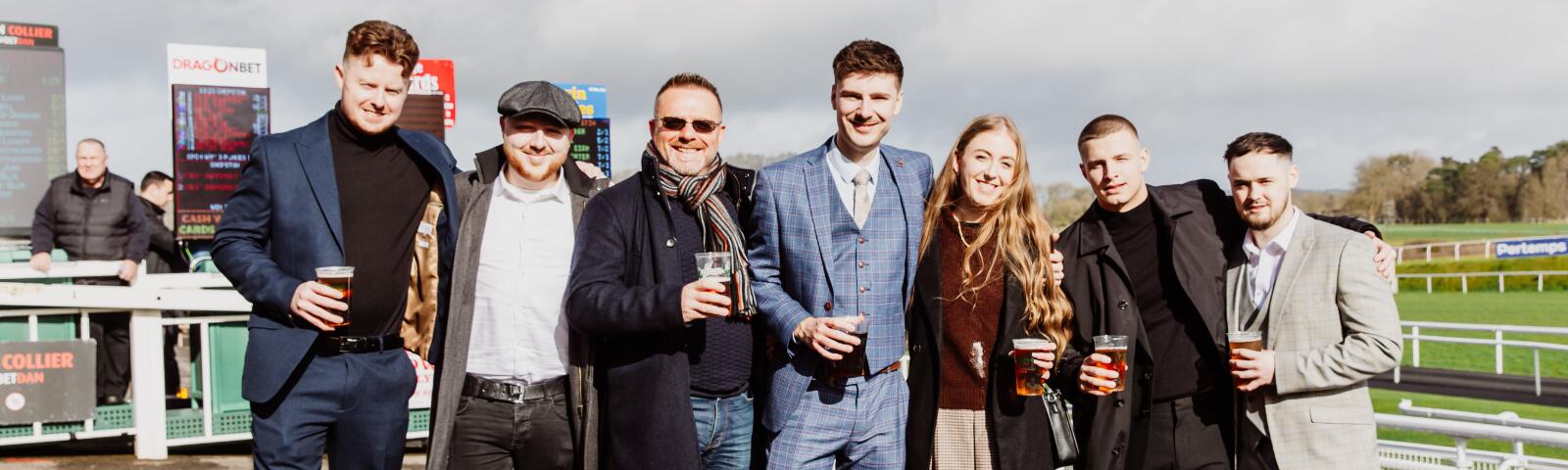 A group of friends dressed warmly for the weather pose at Chepstow Racecourse