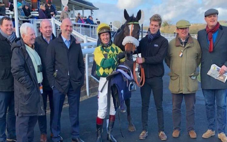 All the team pose for a photograph with their succesfull horse.