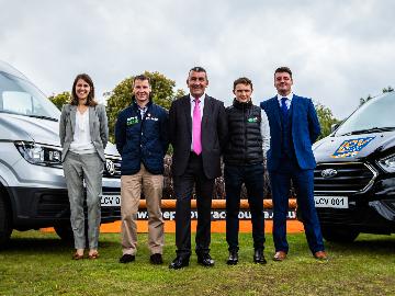 Low Cost Vans team posing for a photo with members of the Chepstow Racecourse team.