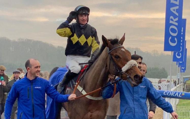 The Welsh Grand National winner is led by handlers to celebrate their win.