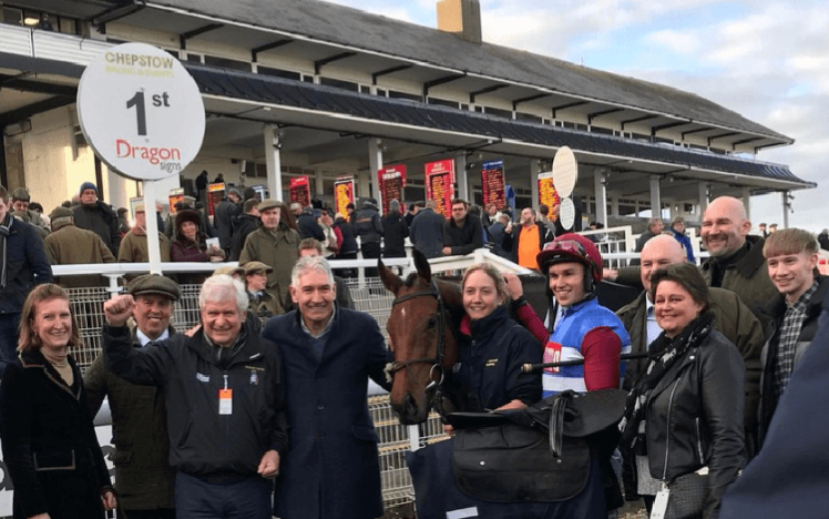 A winning team pose for a photograph